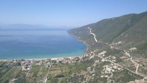 an aerial view of a town on a hill next to the ocean at Katerina Lefkada in Vasiliki
