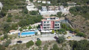 a large building on a hill with a parking lot at Katerina Lefkada in Vasiliki