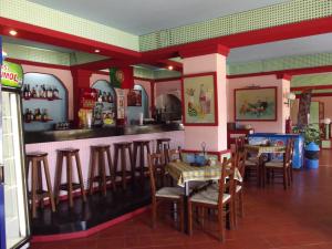 a dining room with tables and chairs in a restaurant at Apartamentos Turisticos Silchoro in Albufeira