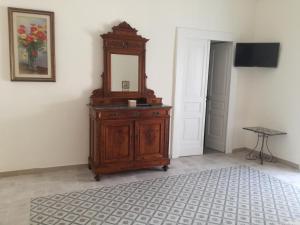 a wooden dresser with a mirror on it in a room at B&B Stella in Vico Equense