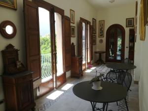 a room with two tables and a balcony at B&B Stella in Vico Equense