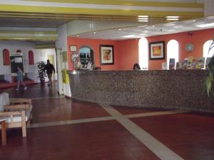 a lobby with a bar in a building at Apartamentos Turisticos Silchoro in Albufeira +61 photos