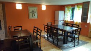 a dining room with a table and chairs and a refrigerator at Sireli Hostel in Suureranna +9 photos