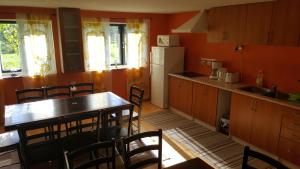 a kitchen with a table and chairs and a refrigerator at Sireli Hostel in Suureranna