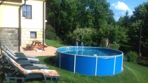 a hot tub in the grass next to a house at Holiday Home Benecko 101 in Benecko
