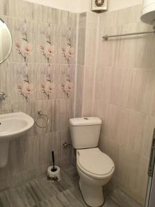a bathroom with a toilet and a sink at Kapka Apartments in Kiten