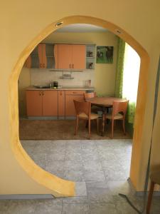 a kitchen with a table and chairs in a room at Kapka Apartments in Kiten +14 photos