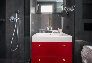 a bathroom with a shower, sink, and mirror at Snob Hotel by Elegancia in Paris