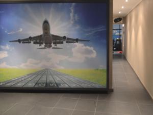 a mural of an airplane flying over a runway at Home in Welkenraedt with Jacuzzi Steam Shower in Welkenraedt