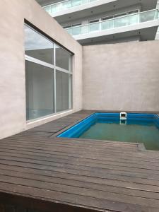 a swimming pool on the deck of a house at Olivos Suites in Olivos