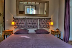 um quarto com uma cama grande e um espelho na parede em La Ribambelle em Saint-Martin-Vésubie
