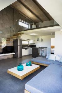 a living room with a couch and a table at Iskios Villas in Agia Marina Nea Kydonias