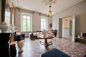 a living room with a table and a couch at LE MANOIR DE CANET D'AUDE in Canet d'Aude