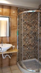 a bathroom with a shower and a sink at Sani Kasimis in Kyparissia