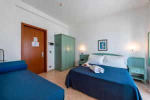 Postel nebo postele na pokoji v ubytování Albergo Villa A Mare