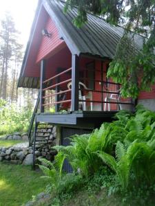 a red house with a porch and a balcony at Sireli Hostel in Suureranna