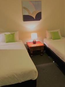A bed or beds in a room at Insaa Serviced Apartments Dandenong