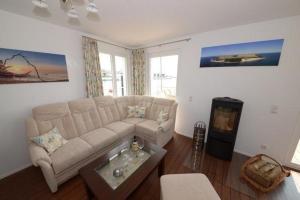 a living room with a couch and a table at Ruegen in Wiek auf Rügen +3 photos