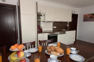 a kitchen with a table with plates of food on it at Ruegen in Wiek auf Rügen