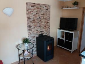 a living room with a fireplace and a tv at Casa Beco Sao Luis in Faro