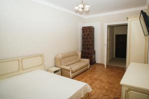 sypialnia z łóżkiem i krzesłem w obiekcie Apartment on Stefanyka 11 w Lwowie