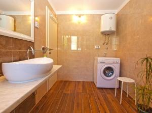 a bathroom with a sink and a washing machine at House Marcana 1156 in Marčana