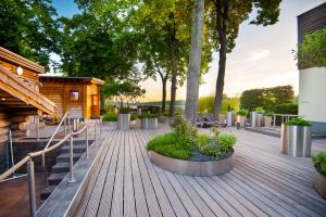 a wooden deck with stairs and trees and a cabin at Aspria Hannover in Hannover