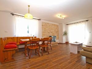 a living room with a wooden table and chairs at House Marcana 1156 in Marčana