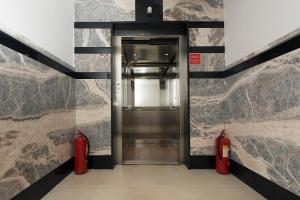 a elevator with two red fire hydrants in a building at Rooms Zvonimir in Split