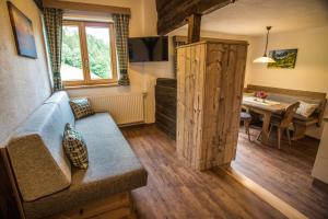 a living room with a couch and a table at Rössingerhof in Ramsau am Dachstein