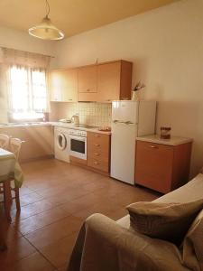 a kitchen with a white refrigerator and a stove at Maria's Apartments in Meyisti