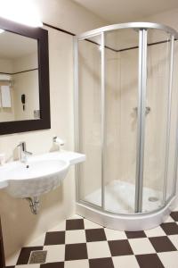 a bathroom with a shower, sink, and toilet at Europa Royale Bucharest in Bucharest