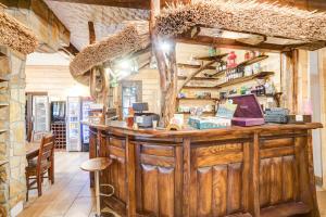 a bar in a restaurant with a counter and chairs at Solny - Resort w Bieszczadach in Cisna