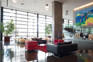 a lobby with couches and chairs in a building at VIP Executive Arts Hotel in Lisbon