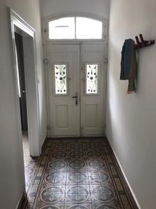 a hallway with a white door and a window at Herrenhaus - Weingut Freiherr v. Landenberg in Ediger-Eller