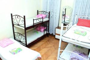 a room with two bunk beds and a mirror at Hostel in Batumi in Batumi