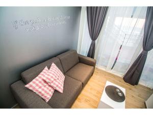 a living room with a couch and a quote on the wall at IDRO Studio Apartments directly at the beach in Split