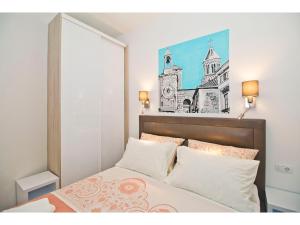 a bedroom with a bed with a picture on the wall at IDRO Studio Apartments directly at the beach in Split