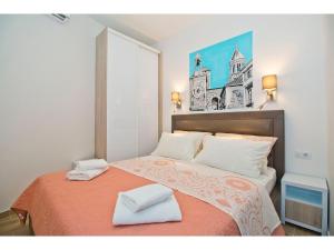 a bedroom with a bed with two towels on it at IDRO Studio Apartments directly at the beach in Split