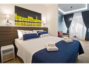 a bedroom with a large bed with towels on it at IDRO Studio Apartments directly at the beach in Split
