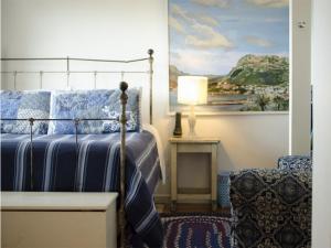 a bedroom with a bed and a painting on the wall at Blue On Blue Bed and Breakfast in St James