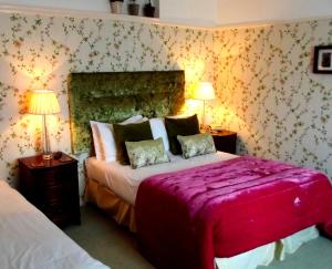 a bedroom with two beds and two lamps at Beachlands Hotel in Weston-super-Mare