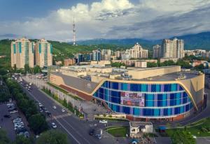 a large building in a city next to a road at Apartments on Samal 1 in Almaty