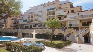 a large apartment building with a fountain in front of it at Studio w La Mata in La Mata