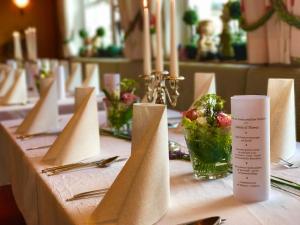 a table with napkins and a bowl of food on it at Gasthof zum See in Wiesensteig