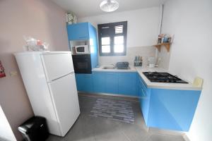 Kuchyň nebo kuchyňský kout v ubytování Résidence Fruit de La Passion Bleu