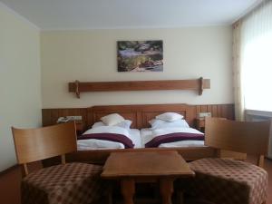 
Ein Bett oder Betten in einem Zimmer der Unterkunft Hotel Ritschlay
