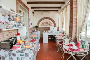 a kitchen with tables and chairs in a room at Villa Erasi in Fiumicino