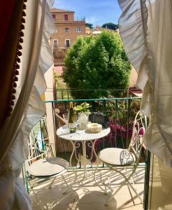 a patio with a table and chairs on a balcony at Borgo Pio 66 Suites in Rome