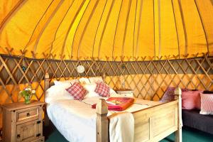 a bedroom with a bed in a yurt at Portsalon Luxury Camping in Portsalon